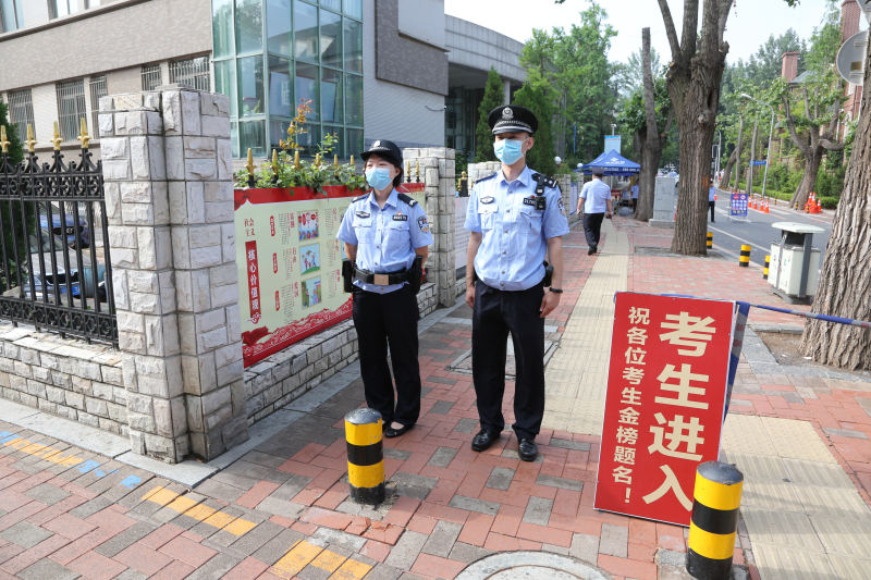 姚曉龍（右）在考場(chǎng)外執(zhí)勤